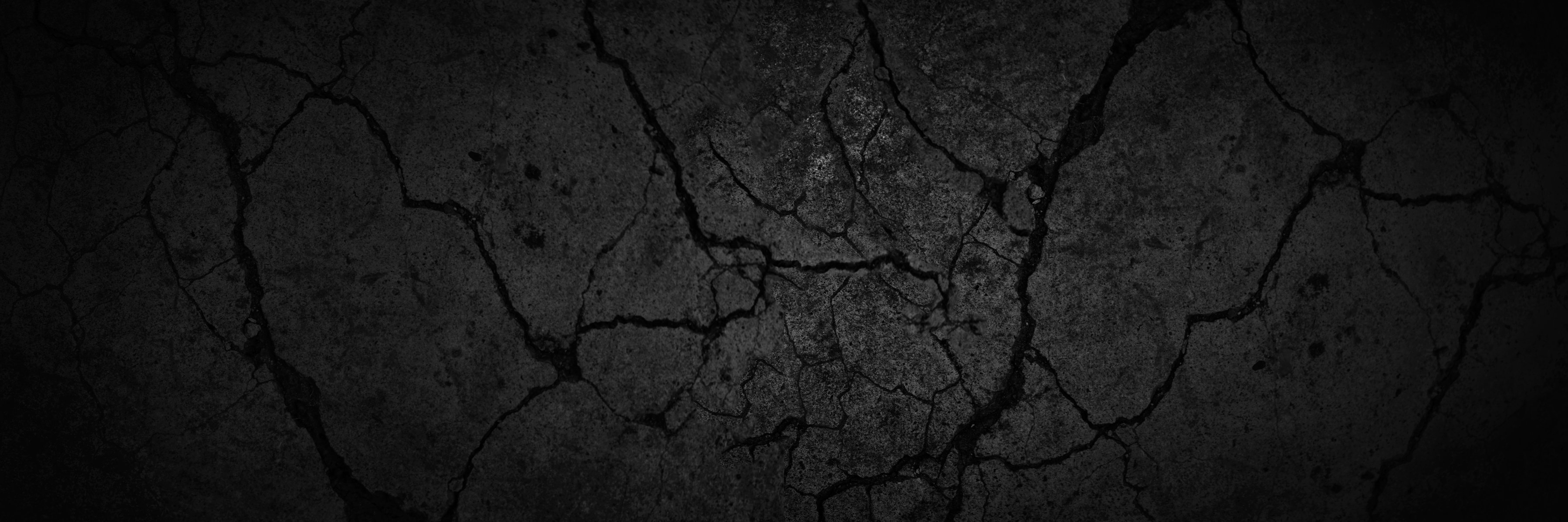 Black and white background. Grunge background. Black stone background with cracks.